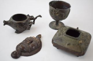 A collection of oriental miniature bronze items to include incense burners together with a carved