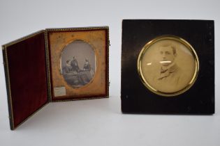 A daguerreotype, 11cm x 13cm together with a later framed photograph of a gentleman in an eboniesd