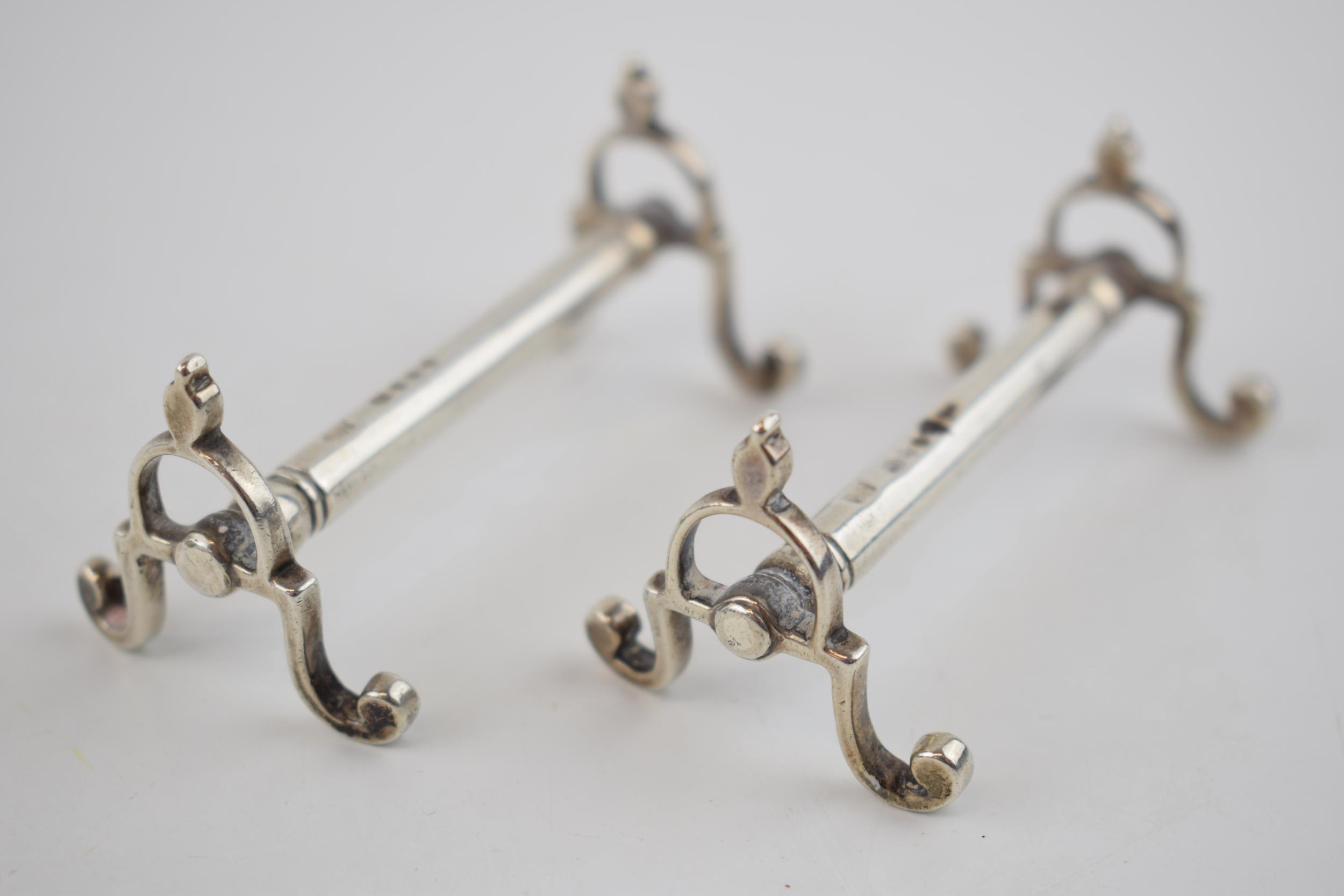 A pair of Victorian silver knife rests, hallmarked London 1849. 72.5 grams. Generally in good