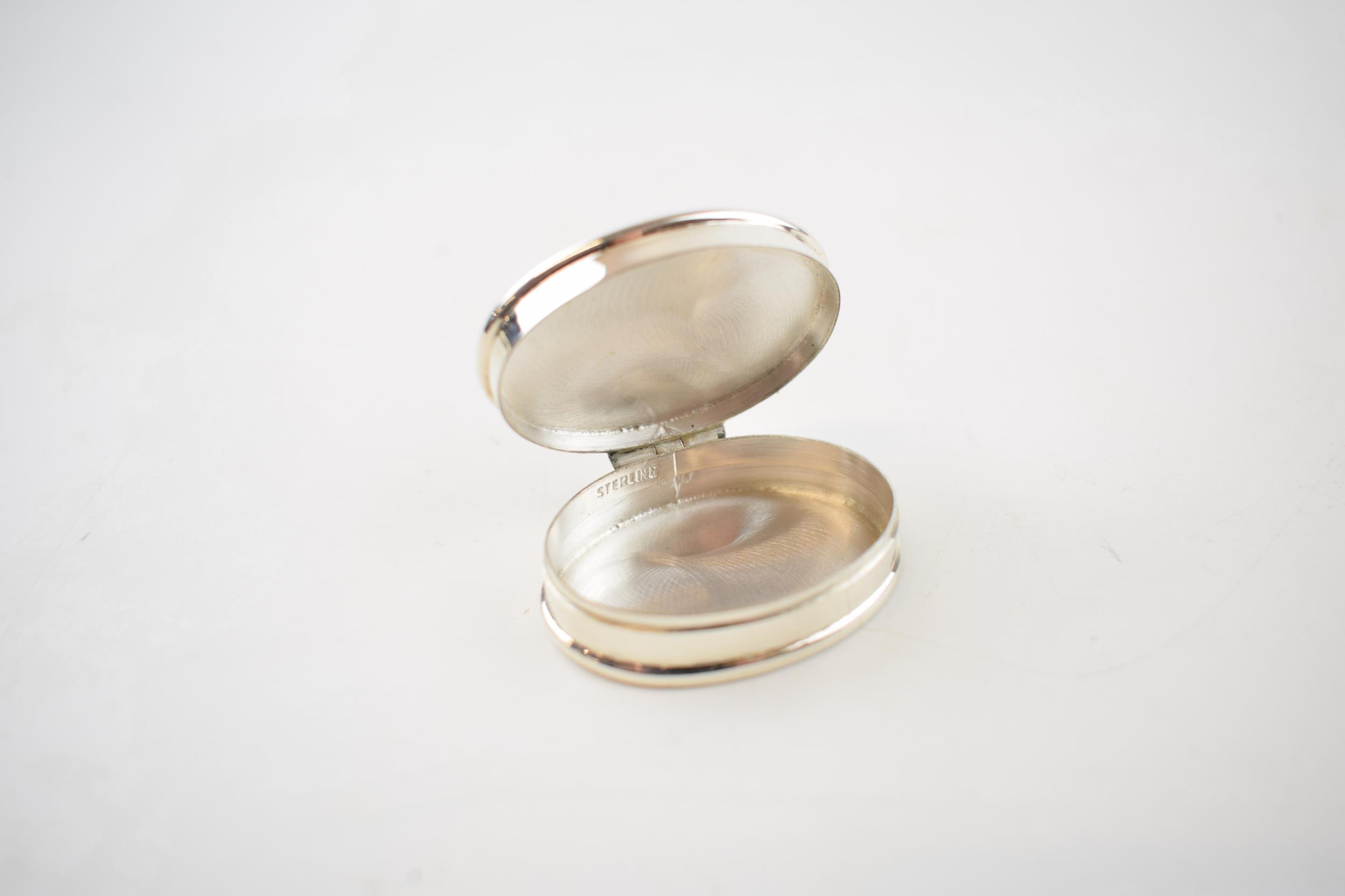 Sterling silver pill box with enamelled insert of a semi-erotic scene, 19.3 grams, 4cm long. - Image 3 of 3