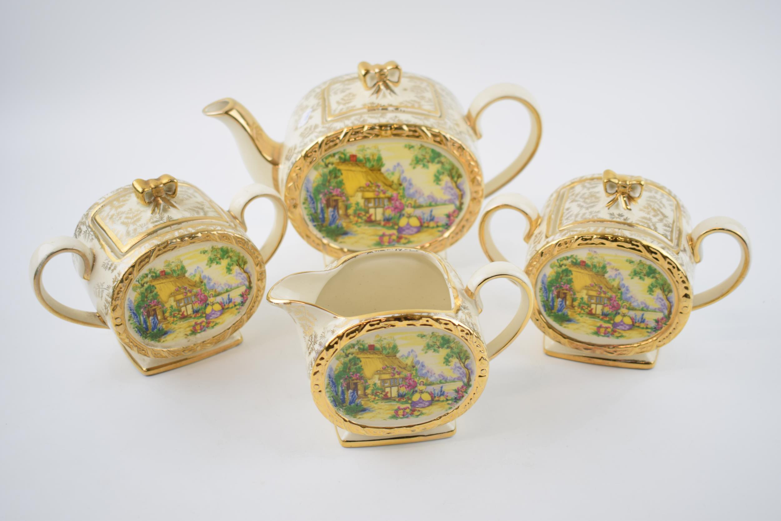 Sadler tea ware in a floral gilt pattern with a cottage scene to include a teapot, 2 lidded sugars