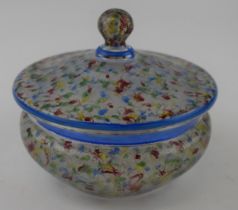 A 1930s glass bonbon dish with red, yellow, green and blue swirl decoration and blue rim. Diameter