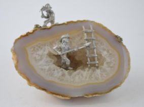 Unusual natural geode with rough cut, in the style of agate, with added mining figures, 12cm wide.