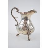 Victorian silver jug with embossed decoration, 169.4 grams, London 1861, 13cm tall.