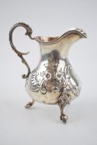 Victorian silver jug with embossed decoration, 169.4 grams, London 1861, 13cm tall.