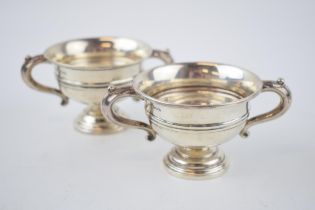 A pair of silver two handled cups / table salts, Sheffield 1929 and 1935, 148.9 grams.