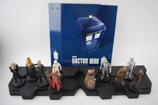 A collection of Doctor Who figures by DW (TM BBC) together with display stand and accompanying