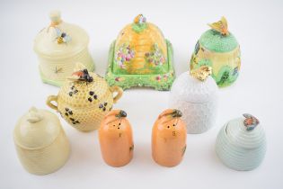 A collection of pottery honey pots in varying forms and colours to include a Cottage Ware example,
