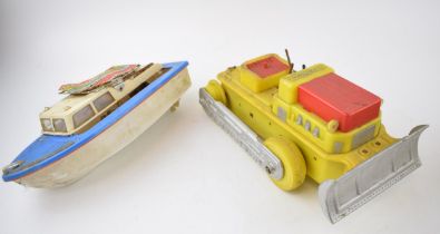 Two early plastic mechanical toys to include a bulldozer and boat. (2) 26cm. In play worn