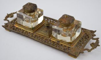 A 19th century brass inkwell stand with gilt wash. Marked F 85 and S REG.D to base. Two original