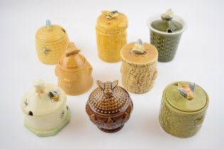 A collection of pottery honey pots in varying forms and colours to include Secla, Crown Devon,