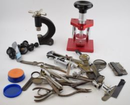 A collection of watchmaker hand tools and presses. Of note are some good quality Swiss made watch