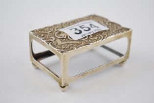 Edwardian silver matchbox holder raised on 4 bun feet, Birm 1903, 8cm wide.