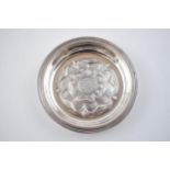 Silver pin tray with repousse Tudor rose design to centre. Hallmarked London 1971. Diameter 9.5cm.