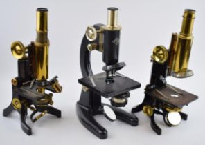 Three scientific microscopes, two by J. Swift & Son, Tottenham Court Road, London together with a