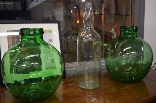 A pair of large Viresa green glass carboys, 35cm tall, together with a Bells Scotch Whisky bottle (