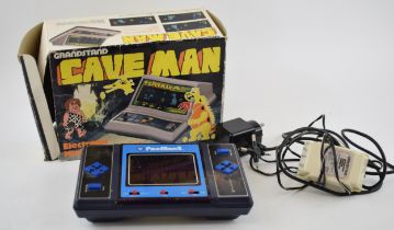 Vintage electronic toys to include boxed Grandstand Cave Man and Pac Man 2. (2) In good used