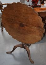 Georgian mahogany pie crust tilt top table on a turned column raised on three swept legs, 81cm