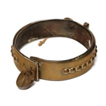 An antique brass dog collar with ball decoration, sliding buckle and original leather insert. Period