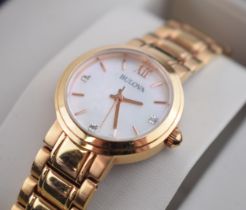 A boxed ladies Bulova quartz wristwatch in rose gold tone case and in original box. Mother of