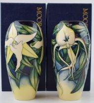 A boxed pair of Moorcroft orchid vases, the first matching pair of vases, one being the Andraecum