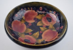 Moorcroft footed bowl decorated in the Pomegranate pattern, 25cm diameter (af). Displays well,