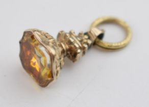 Yellow metal (tests as 9ct gold) ornate fob with citrine style stone, 4.2 grams.