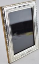 Sterlig silver photo frame with ornate borders, 22.5cm tall, London 2022.