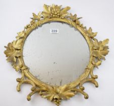 Victorian or earlier carved wooden wall hanging mirror with grape and vine decoration, gilt