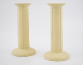 A pair of Wedgwood yellow primrose cane candlesticks, 21cm tall (2). In good condition with no