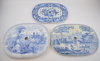 A group of early 19th century blue and white transfer-printed drainers, c. 1825-40. To include