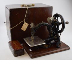 Willcox & Gibbs sewing machine, hand propelled, with wooden carry case / box, with a box of