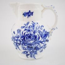 A late 18th, early 19th century blue and white transfer-printed porcelain moulded mask jug decorated