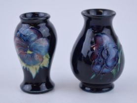 A miniature pair of Moorcroft vases with floral design, 6cm tall (2). In good condition with no