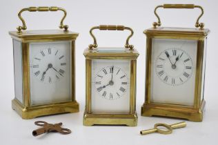 A trio of early 20th century French brass carriage clocks, each with bevelled glass, all unnamed,