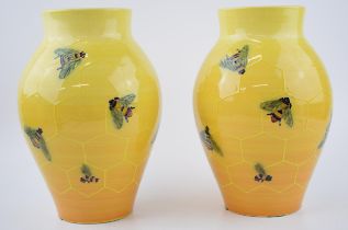 A pair of Dennis China Works bulbous vases, by Sally Tuffin, with a honeycomb and bee design, 24cm