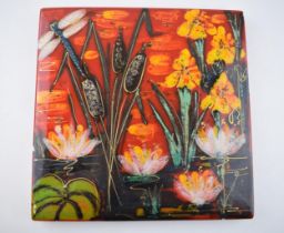 Anita Harris Art Pottery tile, decorated with a pond scene with a dragonfly and reeds, 26.5cm