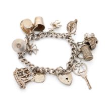 Silver charm bracelet with charms to include a tankard, a key, a bucket and others, 52.6 grams.