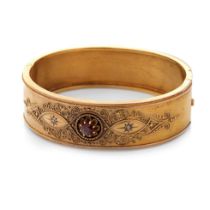 15ct gold (tests as) Egyptian Revival ladies bangle, set with diamonds and a large garnet with