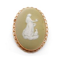 9ct gold framed Wedgwood cameo in early lime green colourway depicting a lady with a large bird,