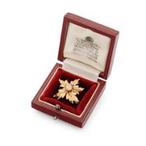 18ct gold brooch in the form of a ladybird sat on foliage, set with old cut diamonds with