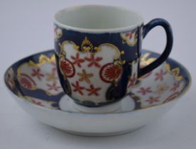 An 18th century Worcester porcelain Japan Star pattern on a blue scale ground cup and saucer, c.