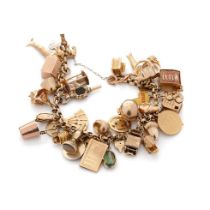 9ct gold charm bracelet with approximately 44 individual charms. Including a 22ct gold 1/3 Guinea