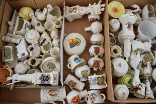 A collection of crested china items to include animals, jugs, vases and varying forms and decoration
