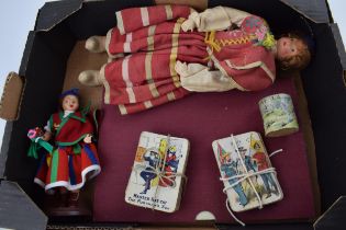 A collection of vintage toy items to include two Madeira dolls, two early packs of pictorial playing