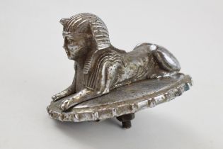 Armstrong-Siddeley car mascot in the form of a recumbant sphinx on oval ridge-edged radiator cap,