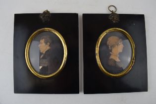 A pair of framed miniature portraits, to include a man and a woman, in black mounts (2), circa 8cm