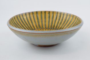 A studio pottery stoneware bowl, with green on mustard yellow decoration, 20.5cm diameter,