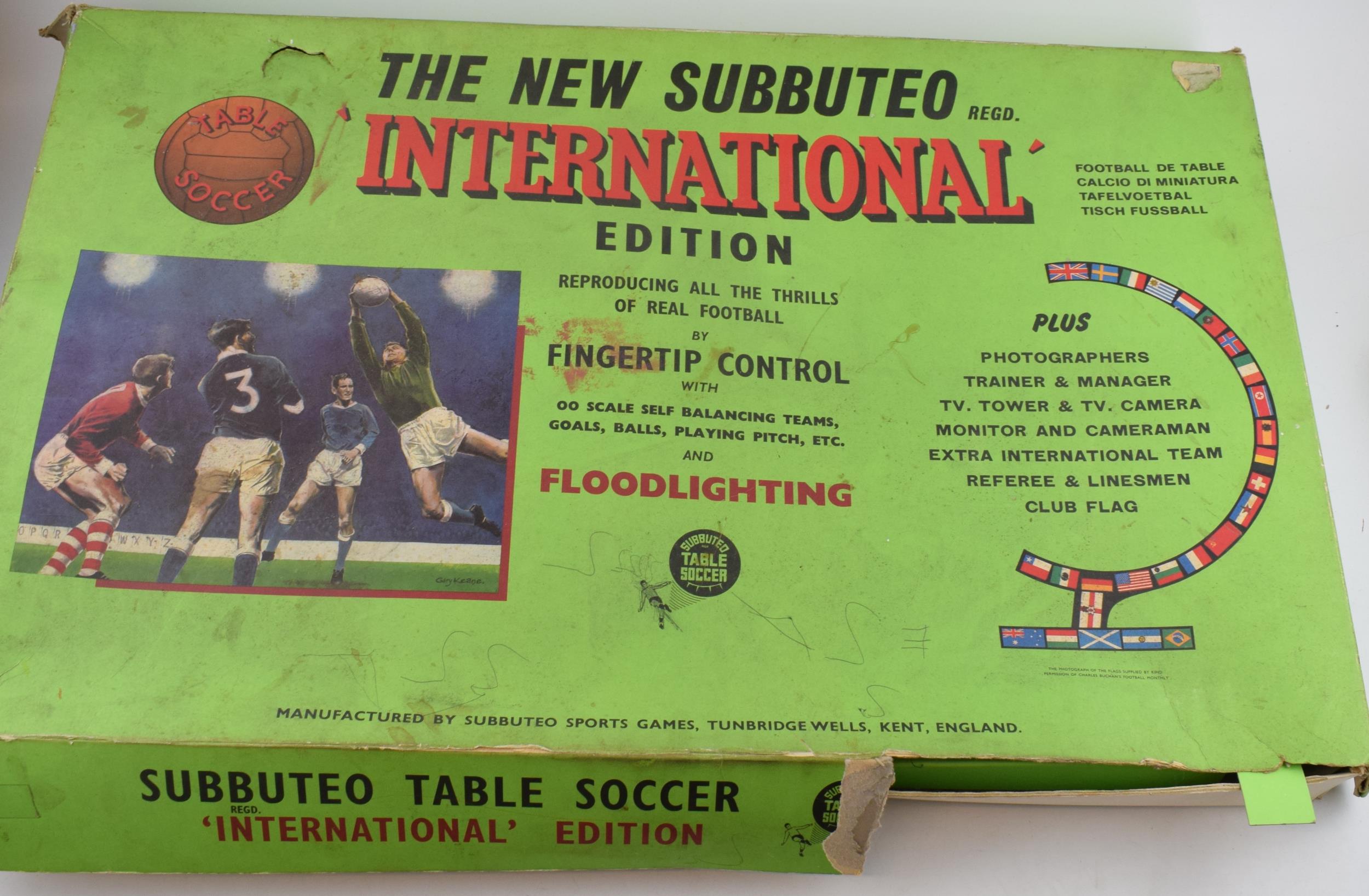 A vintage Subbuteo set with pitch, vintage additional player sets and later flood-lights. a/f. In