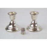 A pair of silver short candlesticks, Birmingham 1961, loaded bases, with a sterling silver